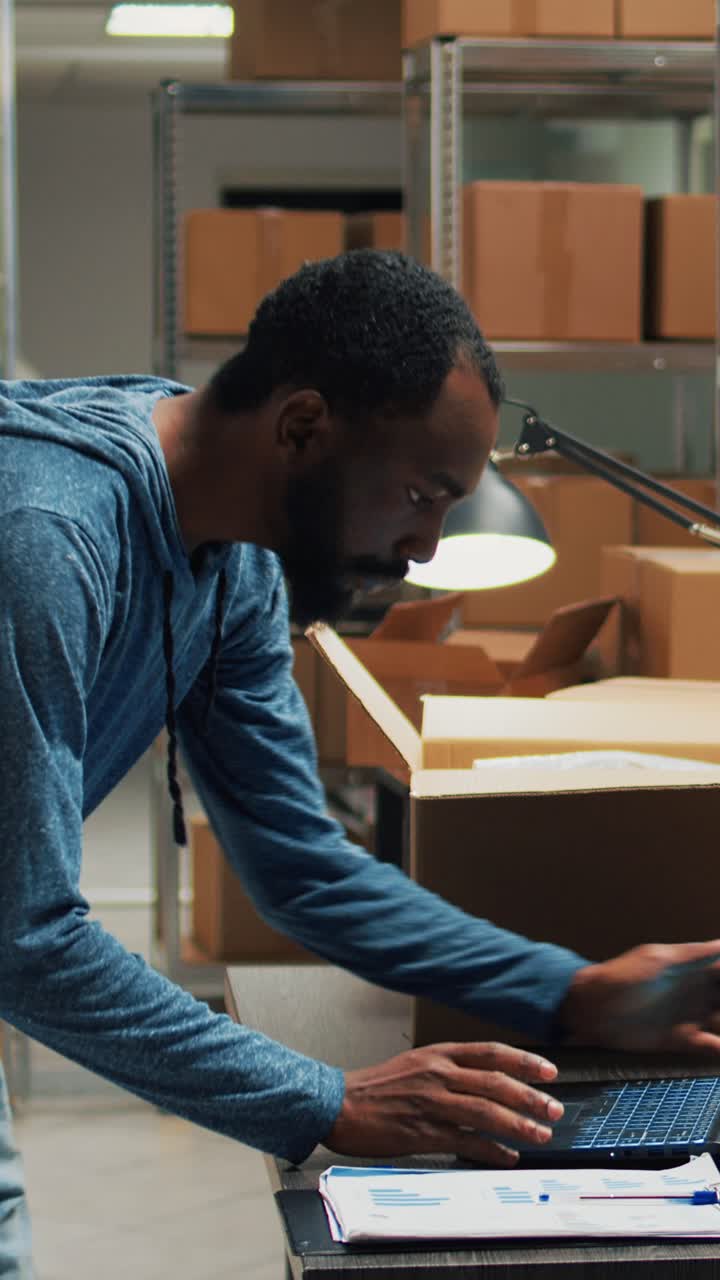 Vertical video: African american owner taking products from storage racks