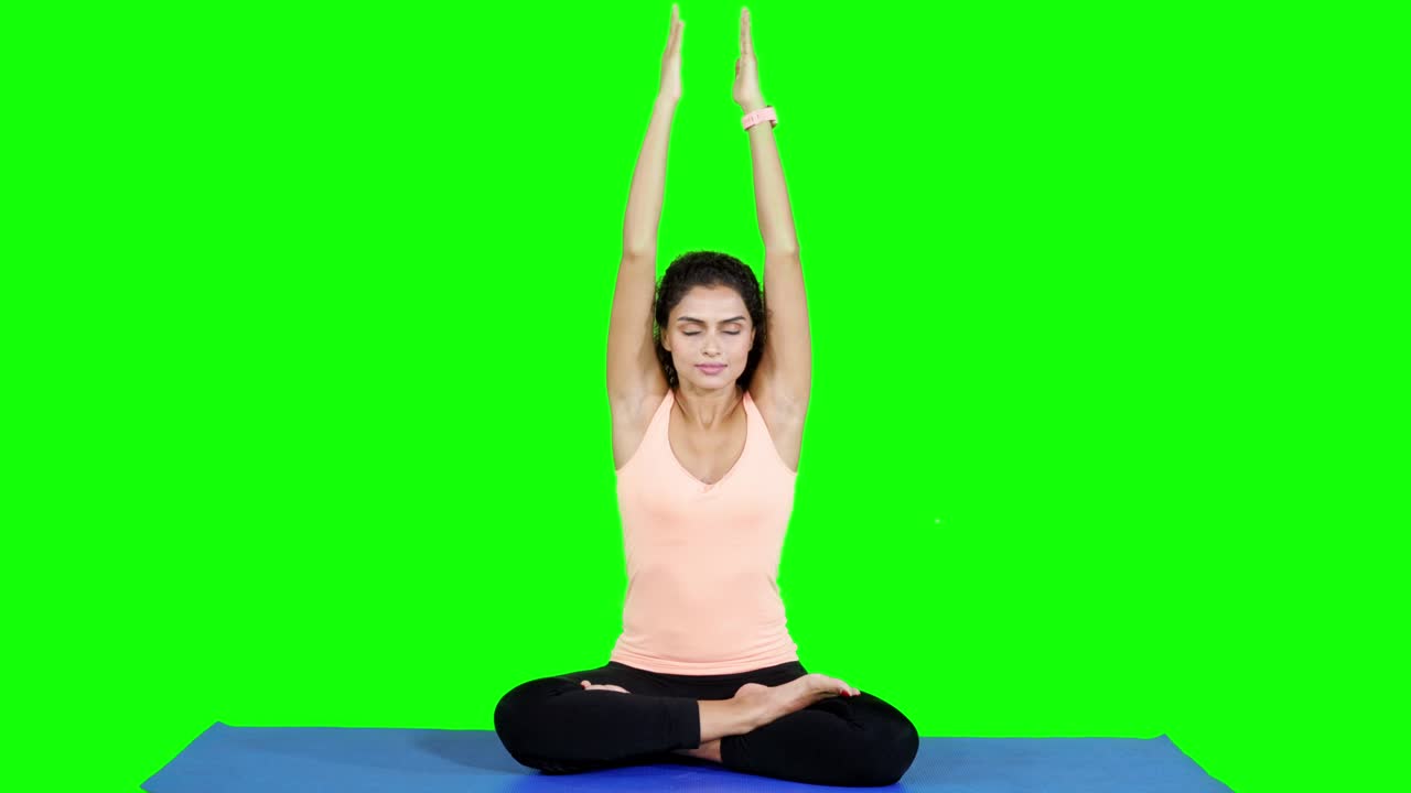 Attractive young woman doing yoga and meditating