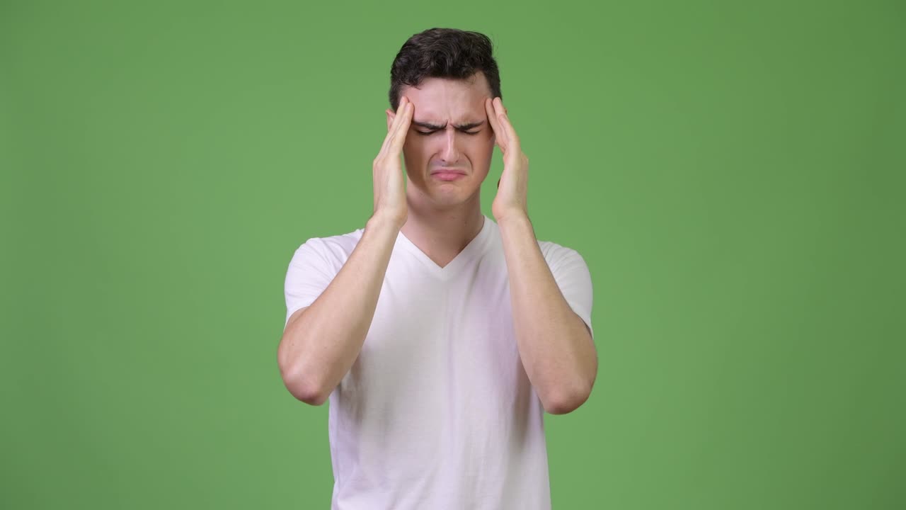 Young handsome man having headache