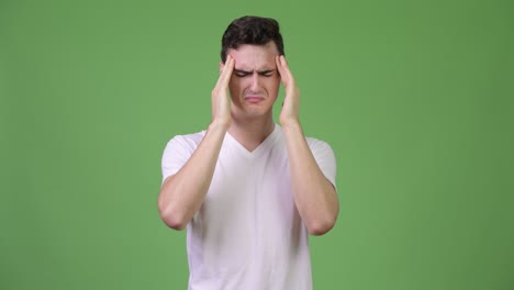 young handsome man having headache