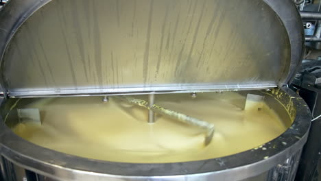 butter production. automated equipment mixing dairy product for making butter. process of making fresh butter on a milk farm. close-up.