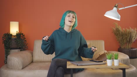 Happy-young-woman-dancing-to-the-camera.