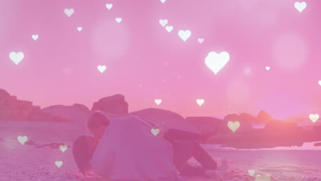 animation of hearts and light spots over diverse couple at beach