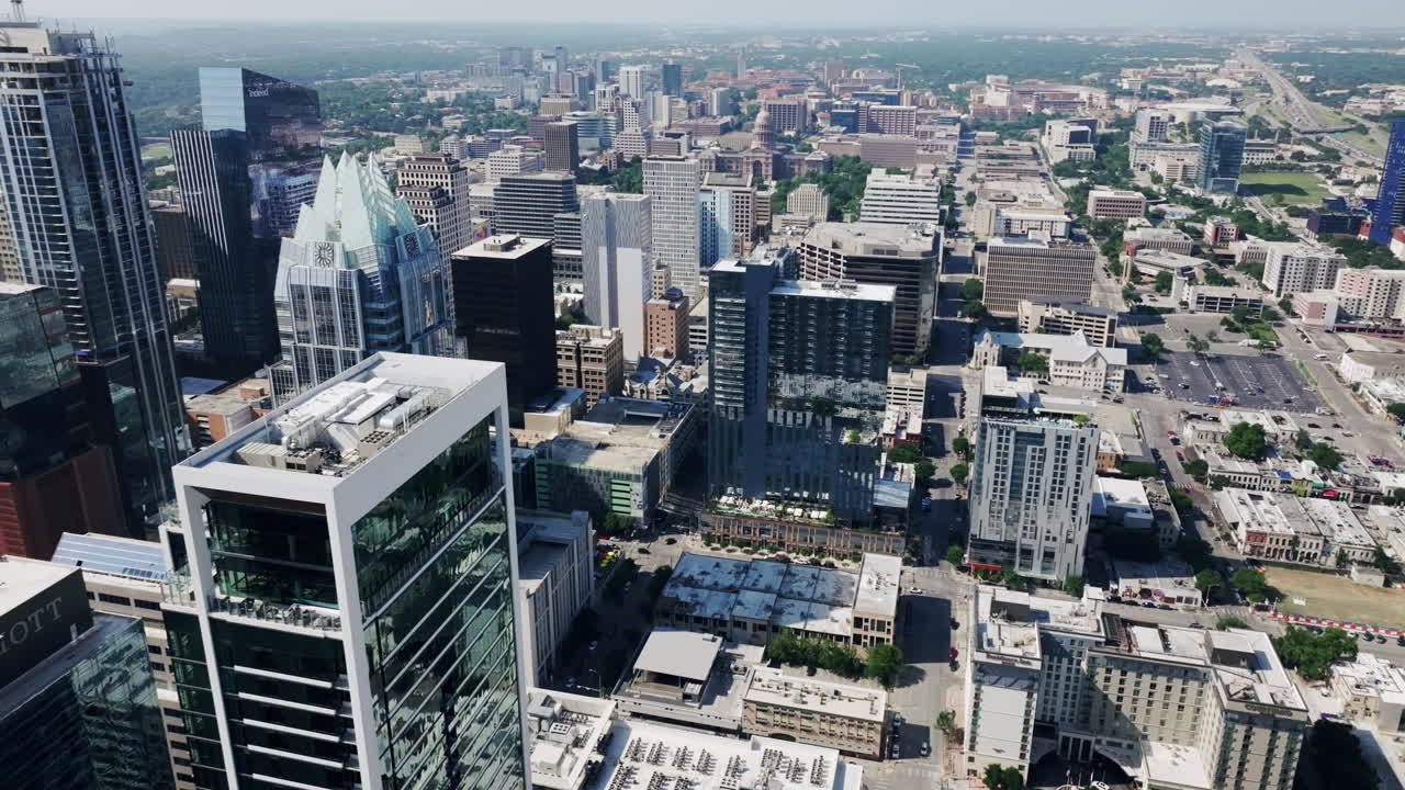 Aerial view of a modern city skyline with numerous skyscrapers and urban development