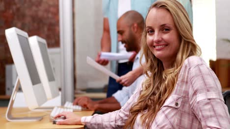 Casual-businesswoman-in-wheelchair-smiling-at-camera