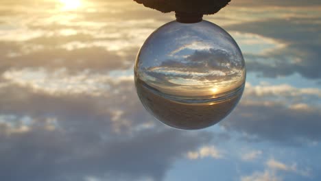 magic sunset view on the beach in a crystal ball.