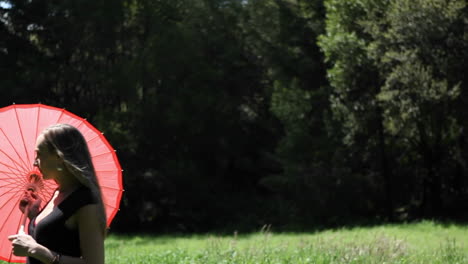 a woman with an umbrella walks in a field