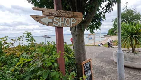 sign pointing to shop near beach area