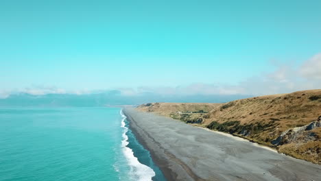 aerial of the azure sea, and majestic landscape of palliser bay, new zealand