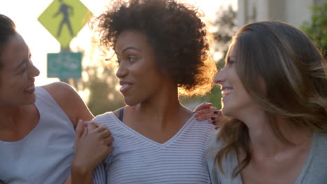 Three-adult-female-friends-in-the-street,-head-and-shoulders