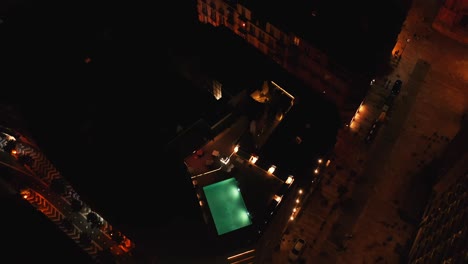 above view of rooftop restaurant with swimming pool in malaga, andalusia, spain at night