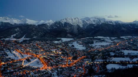 Panoramic-View-Over-Zakopane-Town-In-The-Evening-Of-Winter-In-Poland---drone-shot