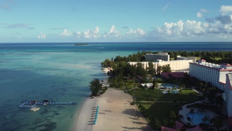 aerial view of hotel and resort along coastline of a tropical island