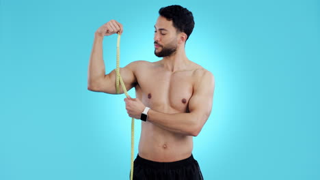 tape measure, man and bicep arm muscle in studio