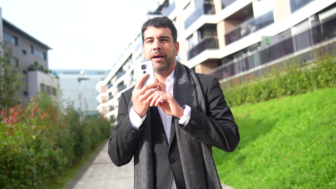 Man in suit using phone in an urban setting