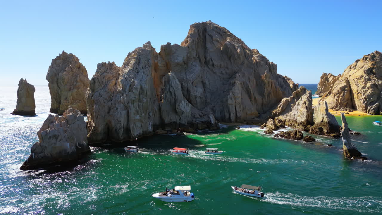 Aerial drone view of the majestic Arch and surrounding cliffs of Cabo San Lucas under clear blue skies
