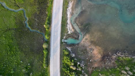 aerial ascent of quarry stream and road out to lake huron, michigan