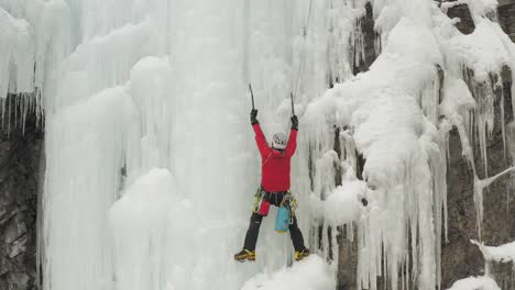 lone climber resting before ascending frozen cliff face mount kineo 4k