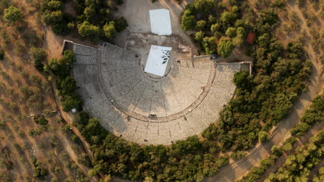 bird's eye view of the famous ancient epidauros amphitheater located in greece near lighourio city - aerial shot