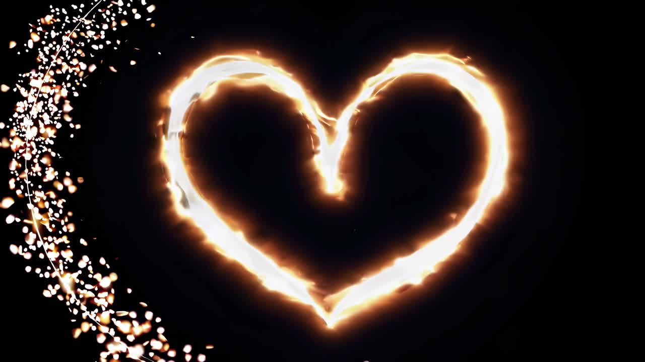 Un cuore incandescente fatto di scintille su uno sfondo nero, ripreso da un’angolazione zenitale