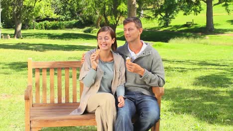 young couple eating icecream and talking