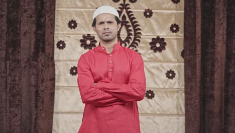 confident indian muslim man standing crossed hands