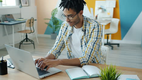 young man working on laptop in modern office