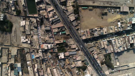 Aerial-view-over-the-streets-of-Huacho-city,-sunny-Peru---top-down,-drone-shot