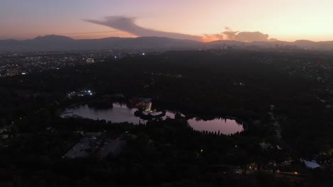 lake lago mayor de chapultepec, vibrant sundown in mexico city - aerial overview