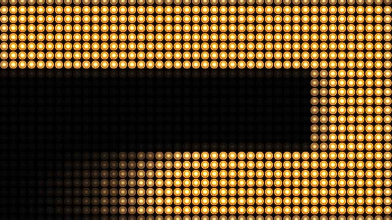 4K zlaté blikající žárovky na LED stěně. Abstraktní animované pozadí. Nebo projektory pro jevištní osvětlení.