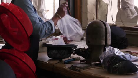 Mixed-race-woman-working-at-a-hat-factory