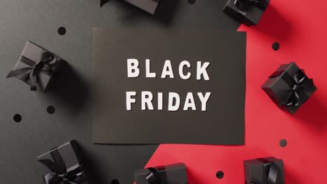 Black-Friday-Text-In-Weiß-Auf-Schwarz-Mit-Schwarzen-Geschenkboxen-Auf-Rotem-Und-Schwarzem-Hintergrund