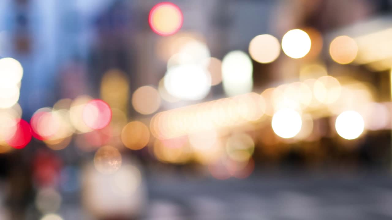 A dynamic display of colorful, out-of-focus city street lights creating a vibrant bokeh effect.