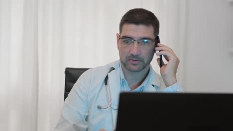 male doctor talking on the phone inside his clinic