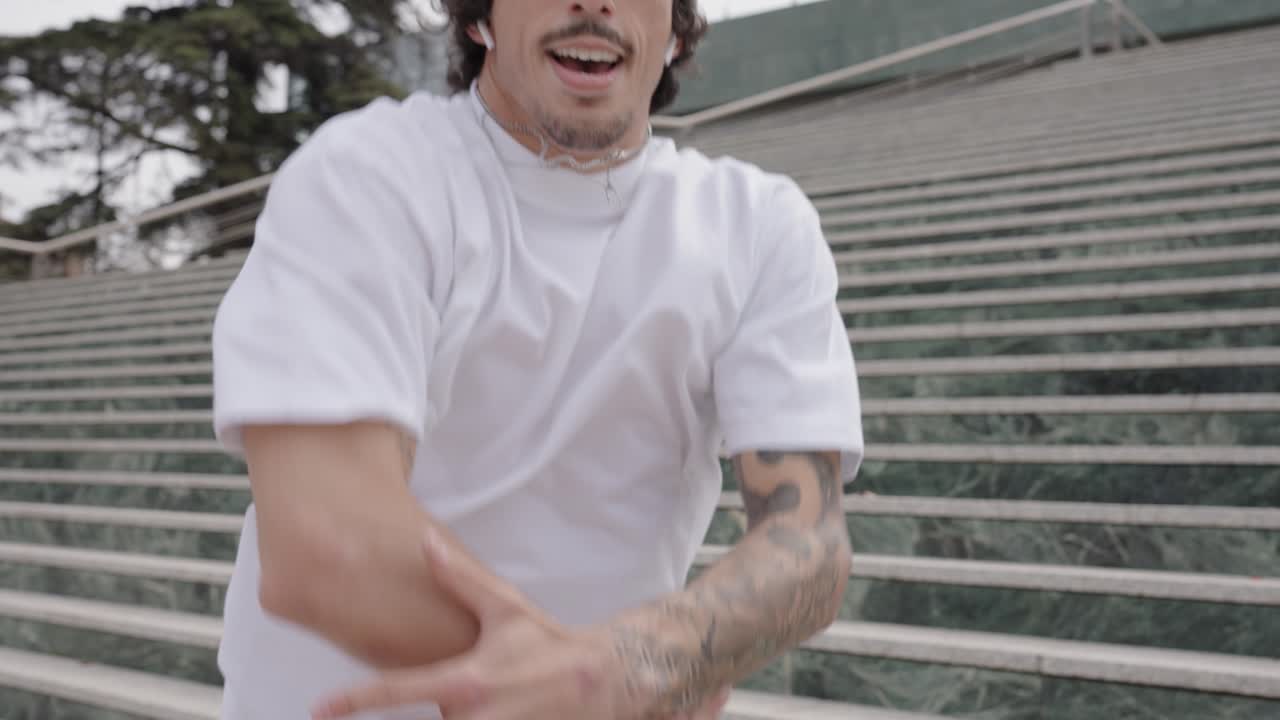 Young man dancing hip hop on urban staircase