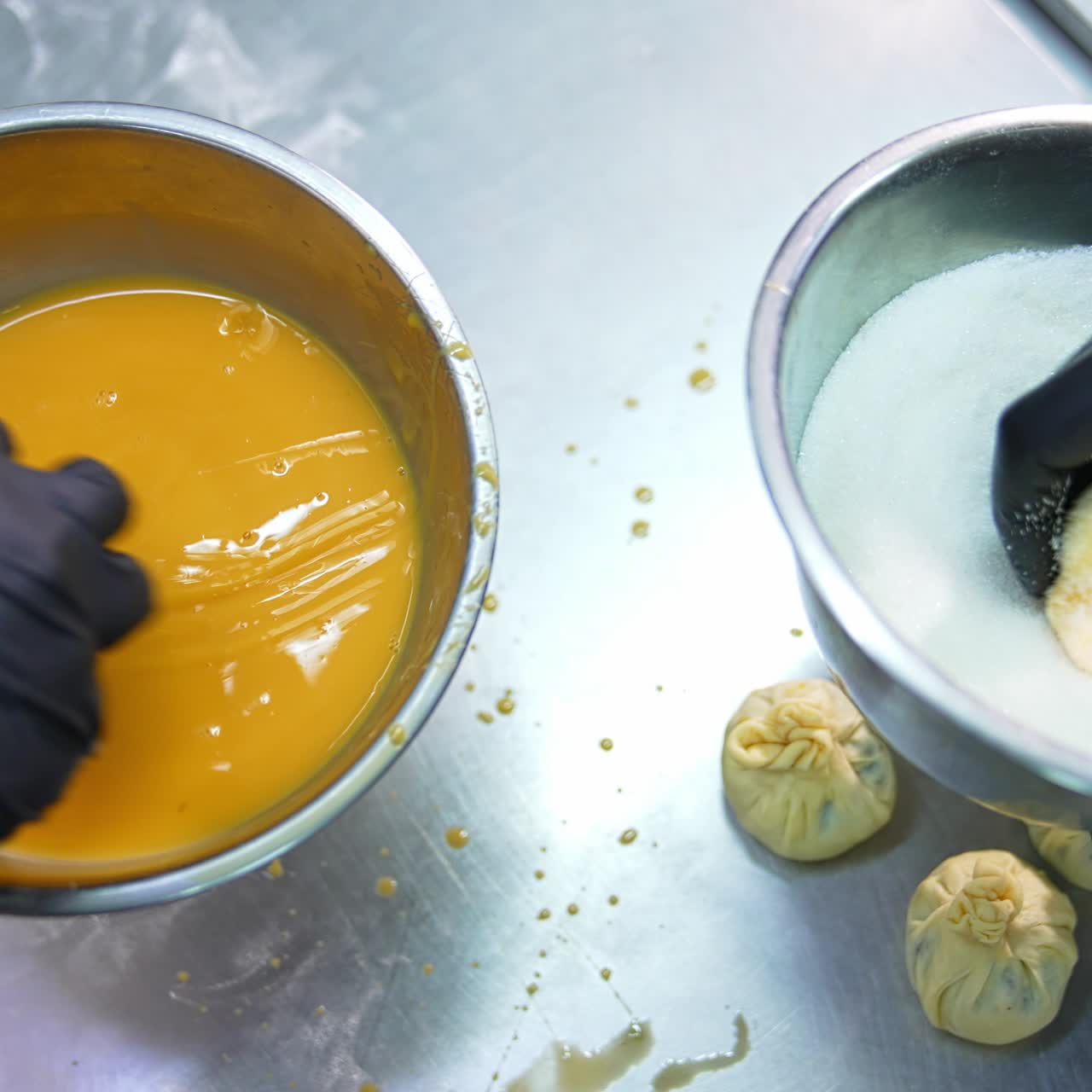 Sweet desserts production at confectionary factory. Handmade desserts coated with egg and sprinkling. Close up