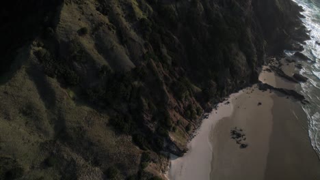 Spectacular-view-of-Cape-Reinga-Lighthouse-over-sandy-beach-reveal-scenic-coastal-landscape-of-New-Zealand