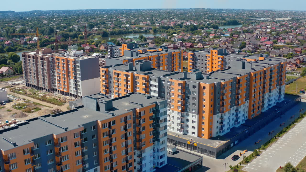 Residential complex with multi-storey buildings. Modern area with new skyscrapers in the outskirts of a city. Colorful architecture of urban housing. Aerial view.