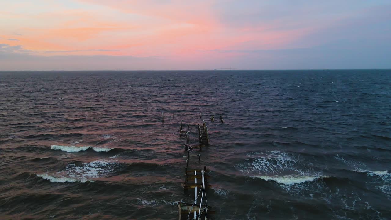 Aerial of the destroyed Rod and Reel Pier in Anna Maria Island, Florida at sunset after Hurricane Milton.