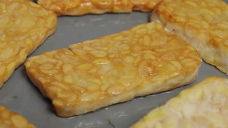 traditional indonesian fermented soybeans called tempeh frying over the pan