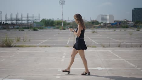 woman walking in a city parking lot