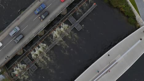 Cinematic-rotating-aerial-shot-of-two-bridges-side-by-side:-traffic-and-pedestrian