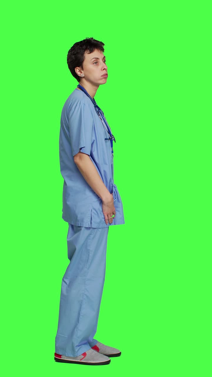 Profile Stressed nurse checks time on watch and waiting for patient to arrive at checkup