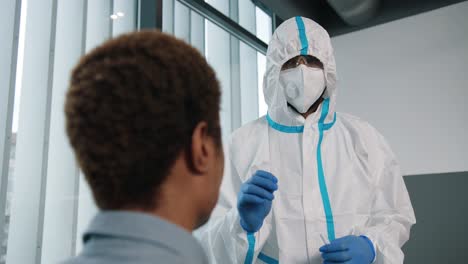 Close-Up-Of-Healthcare-Worker-In-Protective-Uniform-And-Medical-Mask-Taking-Saliva-Sample-For-Coronavirus-From-Male-Patient-For-Test,-Pcr-Testing-In-Hospital,-Covid-19-Virus