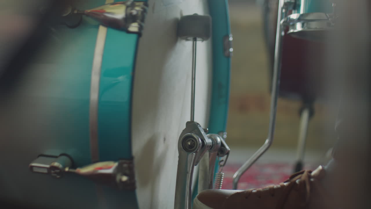 Close-up of a foot playing a bass drum pedal