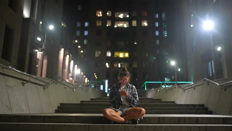 woman sitting on stairs at night