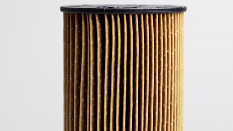 dirty spent fuel car filter on white background. concept of high quality car fuel, fuel cleaning, macro, industry