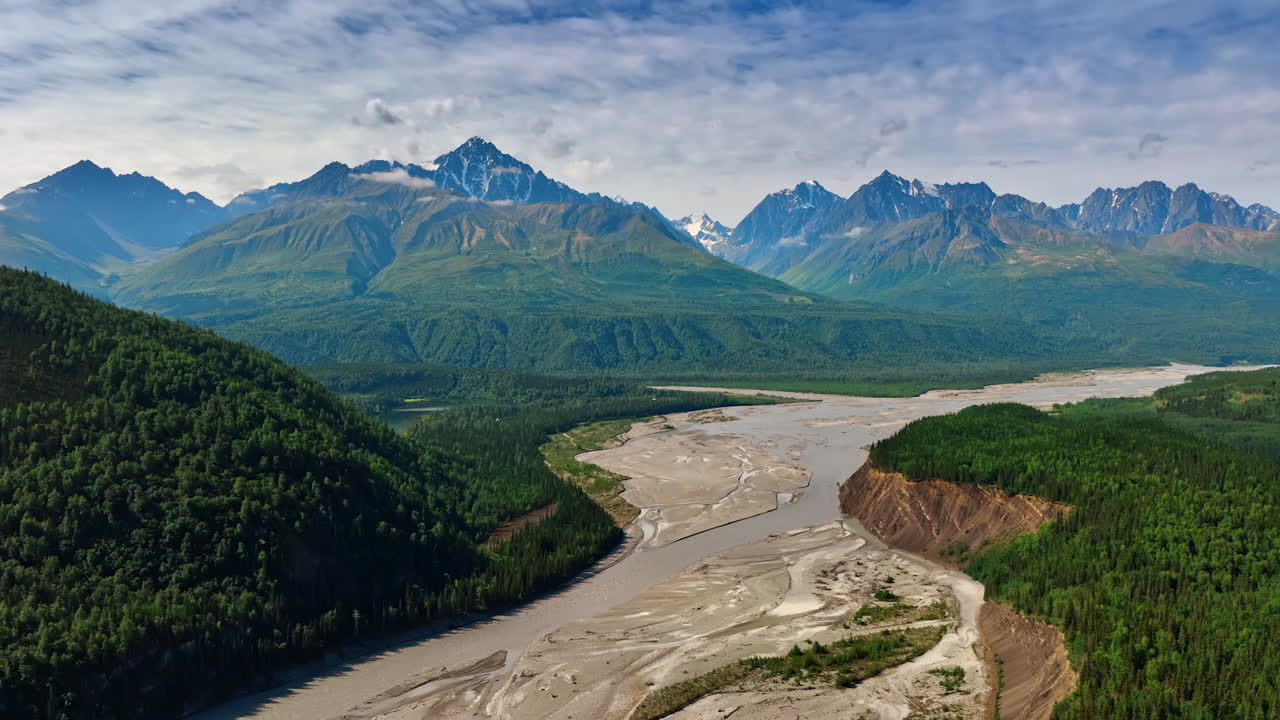 Stunning Alaskan landscapes. Majestic mountains and lush forests encircle a winding river in Alaska pristine wilderness, perfect for exploring