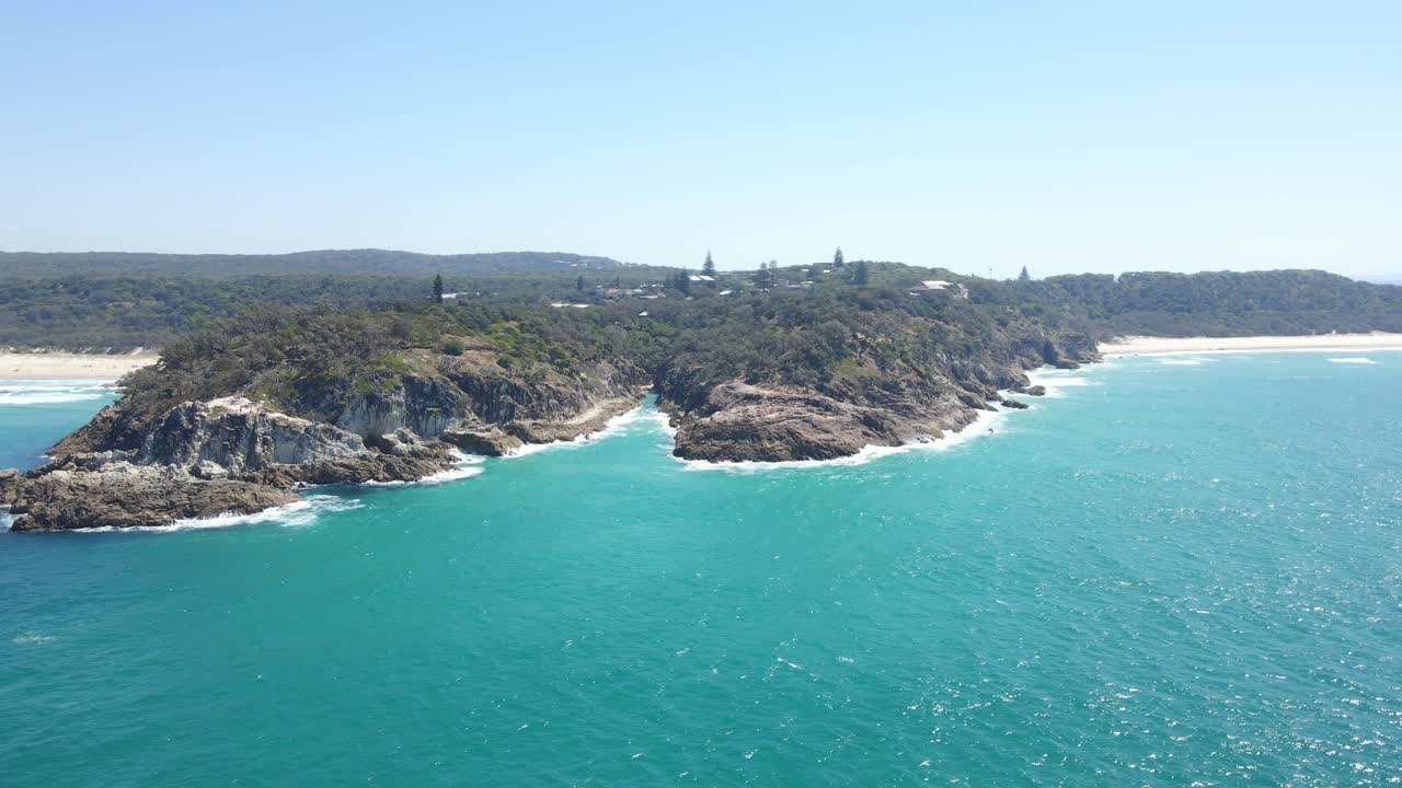 un exuberante bosque verde cubría el promontorio y la arena blanca de la playa frenchmans en queensland, australia