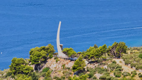 AERIAL:-People-at-the-Wings-Monument,-in-Makarska-riviera,-Croatia,-sunny-day